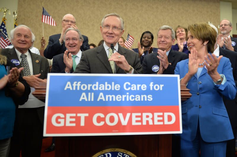 Senate Democratic leader Harry Reid and House Democratic leader Nancy Pelosi celebrate the start of open enrollment for the Affordable Care Act in Washington, D.C., on October 1, 2013. On November 13, the government announced more than 106,000 people had signed up for health insurance covered under the ACA within its first month. File Photo by Kevin Dietsch/UPI