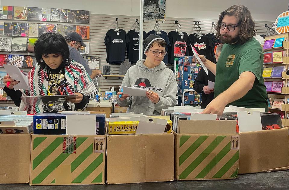 Employees at Dearborn Music work to fill customers' wish lists of exclusive music titles and merchandise for the 16th annual Record Store Day on Saturday, April 20, 2024.