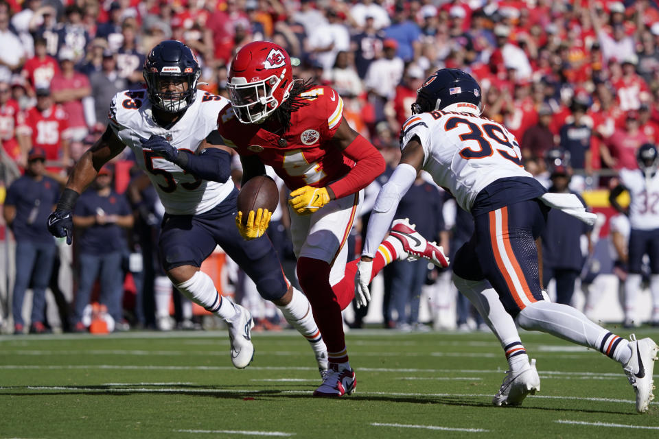 Kansas City Chiefs wide receiver Rashee Rice (4) runs with the ball as Chicago Bears linebacker T.J. Edwards (53) and cornerback Josh Blackwell (39) defend during the first half of an NFL football game Sunday, Sept. 24, 2023, in Kansas City, Mo. (AP Photo/Ed Zurga)