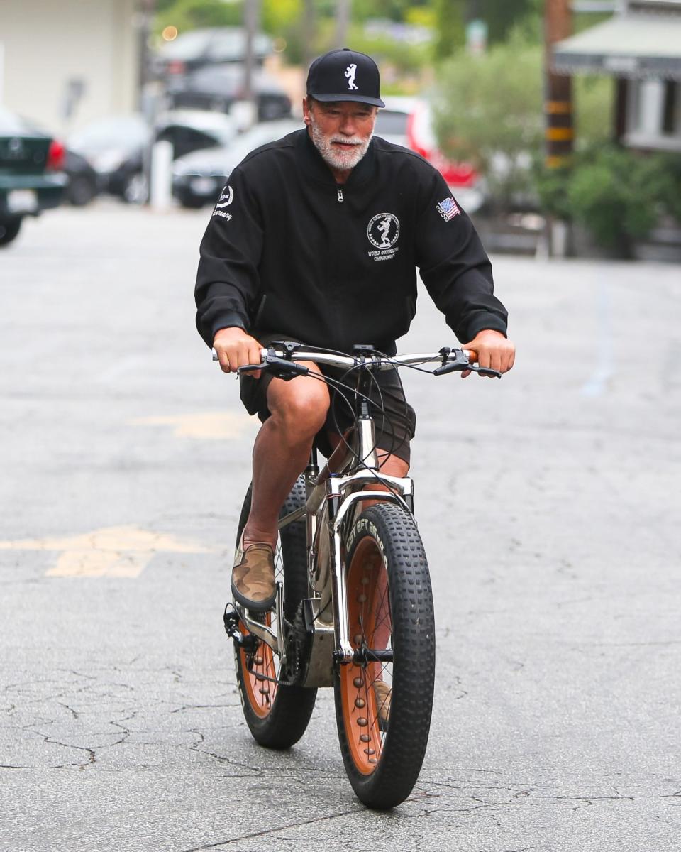 <p>Arnold Schwarzenegger takes a solo spin around his Los Angeles neighborhood on Wednesday.</p>