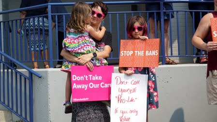 Abortion rights advocates attend a rally after a judge granted a temporary restraining order on the closing of Missouri's sole remaining Planned Parenthood clinic in St. Louis