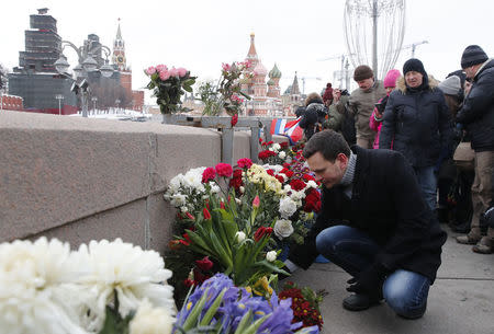 Russian opposition figure Ilya Yashin (front) visits the site of the assassination of opposition leader Boris Nemtsov while marking the third anniversary of Nemtsov's death in central Moscow, Russia February 25, 2018. REUTERS/Maxim Shemetov