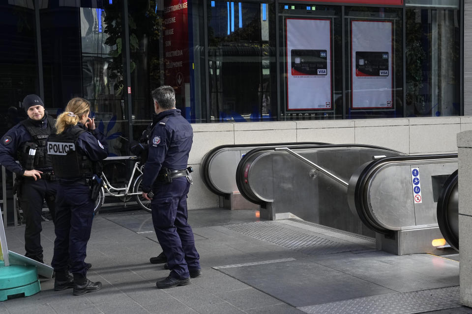 Police officers patrol by a subway station after a woman allegedly made threatening remarks on a train, Tuesday, Oct. 31, 2023 in Paris. Paris police opened fire on a woman who allegedly made threatening remarks on a train, the latest security incident in the country that has been on heightened anti-terror alert since a fatal stabbing at a school blamed on an Islamic extremist.(AP Photo/Michel Euler)