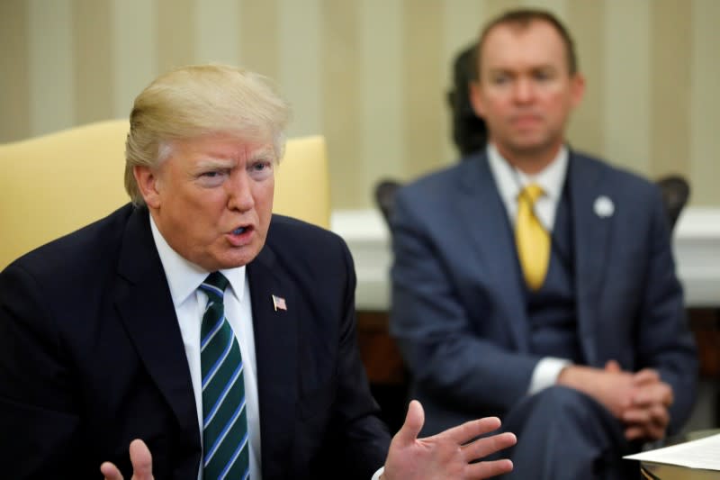 U.S. Office of Management and Budget (OMB) Director Mick Mulvaney (R) listens as U.S. President Donald Trump (L) meets with members of the Republican Study Committee at the White House in Washington, U.S. March 17, 2017. REUTERS/Jonathan Ernst 