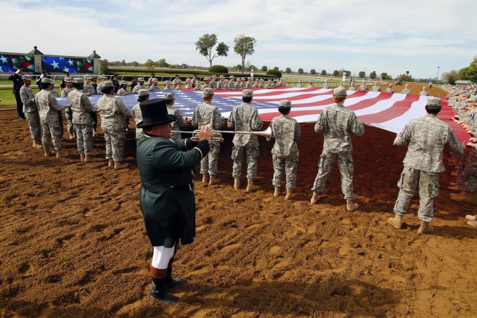 It’s a tradition for a giant flag to be draped out on the track at Keeneland on Military Day.