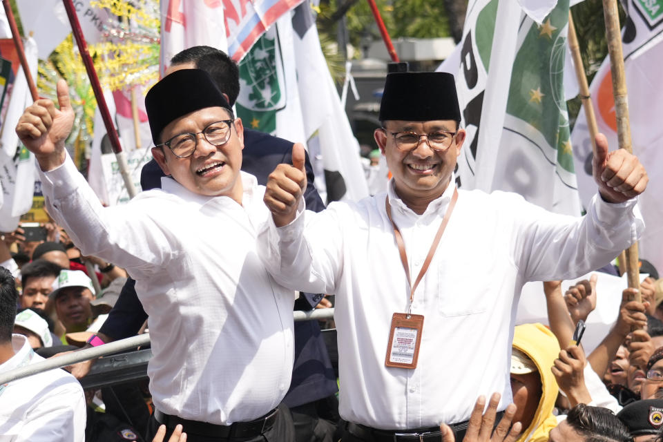 FILE - Presidential candidate Anies Baswedan, right, and his running mate Muhaimin Iskandar greet supporters upon arrival to register themselves to run in next year's election at the General Election Commission building in Jakarta, Indonesia, on Oct. 19, 2023. Indonesia's Election Commission announced Monday Nov. 13, 2023 that it has approved all three presidential candidates for next February's election, including a former special forces general whose vice presidential running mate is the son of outgoing President Joko Widodo. (AP Photo/Achmad Ibrahim, File)