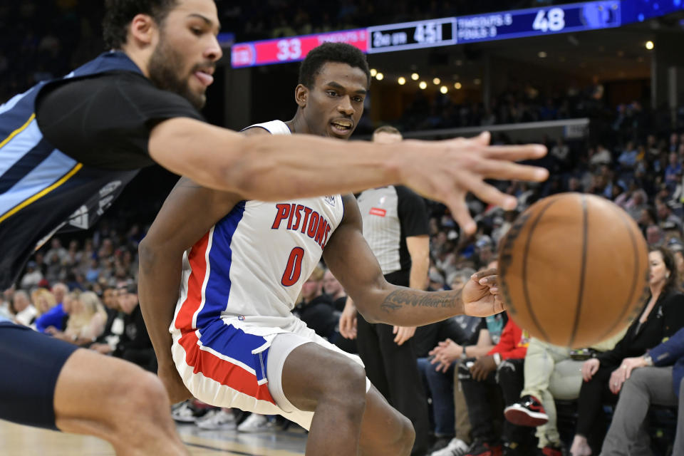 Detroit Pistons center Jalen Duren (0) and Memphis Grizzlies forward Maozinha Pereira, left, reach for the ball in the first half of an NBA basketball game Friday, April 5, 2024, in Memphis, Tenn. (AP Photo/Brandon Dill)