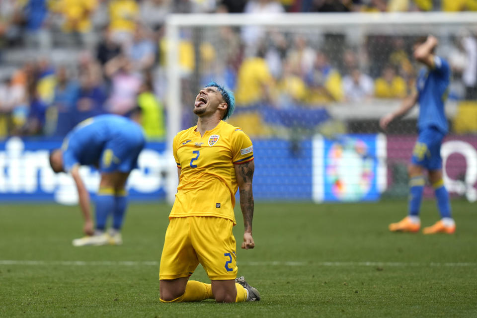 Romania's Andrei Ratiu celebrates after the Group E match between Romania and Ukraine at the Euro 2024 soccer tournament in Munich, Germany, Monday, June 17, 2024. (AP Photo/Matthias Schrader)