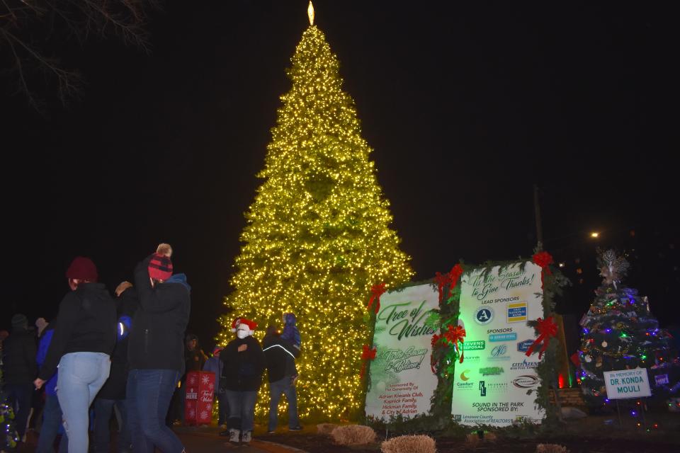 A now 39-foot-tall artificial Christmas tree is lighted for the holiday season in Adrian's Comstock Park. The "Tree of Wishes" was lit along with several hundred other trees during Friday's Comstock Christmas Riverwalk lighting ceremony.