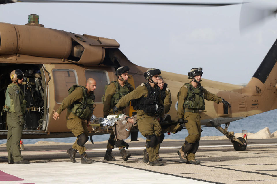 A wounded Israeli soldier is brought to a hospital in Haifa, Israel, Tuesday, March 18, 2014. A roadside bomb hit an Israeli patrol near the frontier with the Golan Heights on Tuesday, the army said, wounding four soldiers in the most serious violence to strike the area since the Syrian conflict began three years ago. Israel said it responded with artillery strikes on Syrian army targets. Israel captured the Golan Heights from Syria in the 1967 Middle East war and later annexed the strategic area in a move that was not internationally recognized. (AP Photo/Hertzel Shapira) ****ISRAEL OUT***