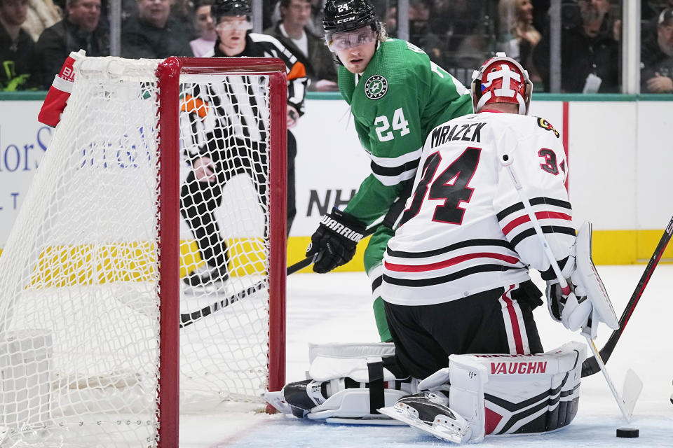 Dallas Stars center Roope Hintz (24) tries to score against Chicago Blackhawks goaltender Petr Mrazek (34) during the first period of an NHL hockey game in Dallas, Friday, Dec. 29, 2023. (AP Photo/LM Otero)