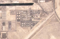 In this satellite image provided by Planet Labs PBC, an Abu Dhabi National Oil Co. fuel depot in the Mussafah neighborhood of Abu Dhabi, United Arab Emirates, is seen Saturday, Jan. 15, 2022, before being targeted in an attack days later. A drone attack claimed by Yemen's Houthi rebels targeting a key oil facility in Abu Dhabi killed three people on Monday, Jan. 17, 2022, and sparked a fire at Abu Dhabi's international airport. (Planet Labs PBC via AP)