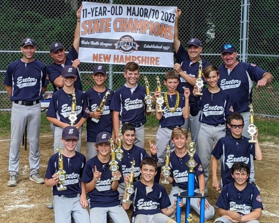 Members of the Exeter 11-year-old Cal Ripken all-star team celebrate after beating Dover, 8-1 in the state championship game at Walsh Field in Exeter. Exeter advances to the regional tournament which begins Friday in Milford, Connecticut.