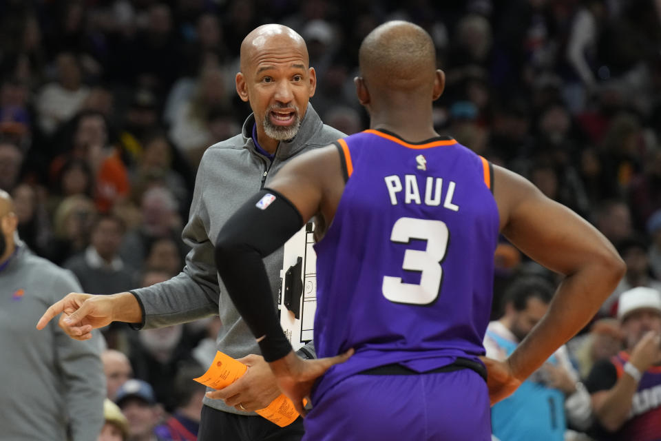 Phoenix Suns head coach Monty Williams, left, talks to guard Chris Paul (3) during the first half of an NBA basketball game against the Los Angeles Lakers, Monday, Dec. 19, 2022, in Phoenix. (AP Photo/Rick Scuteri)