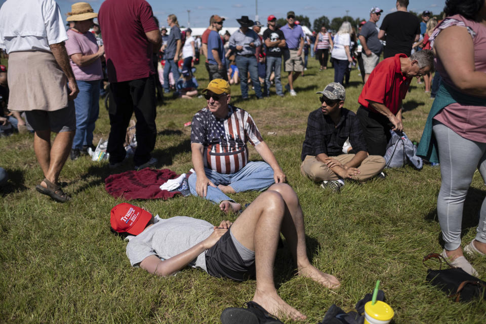 Hours before the start of the program, a supporter catches a nap before the start of former president Donald Trump's Save America rally in Perry, Ga., on Saturday, Sept. 25, 2021. (AP Photo/Ben Gray)