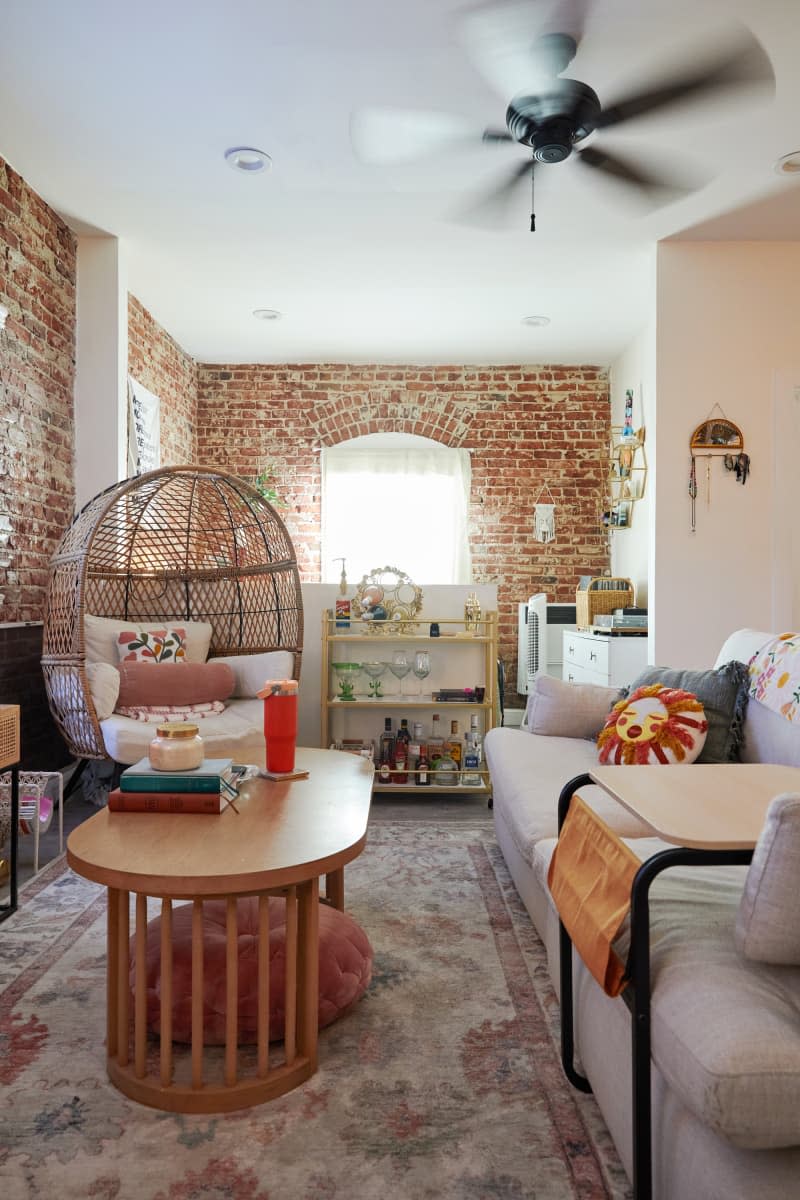 Decorated living room with a large chair, couch, and other items.