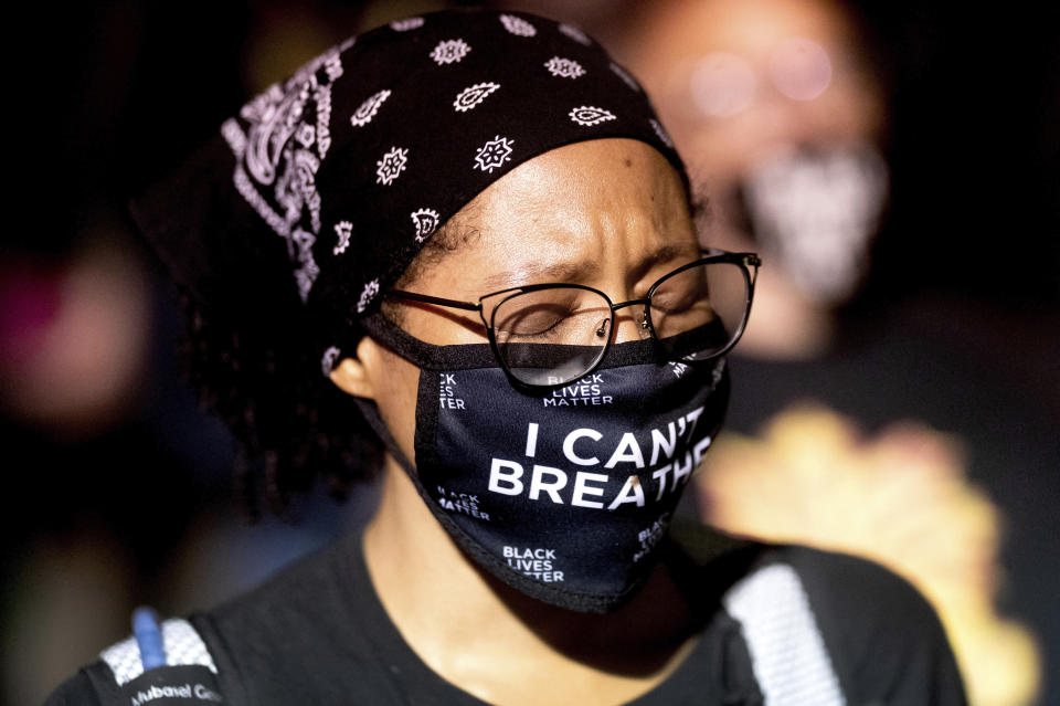 Black Lives Matter protester Synnamon, who declined to give a last name, rallies at the Mark O. Hatfield United States Courthouse on Saturday, Aug. 1, 2020, in Portland, Ore. Following an agreement between Democratic Gov. Kate Brown and the Trump administration to reduce federal officers in the city, nightly protests remained largely peaceful without major confrontations between demonstrators and officers. (AP Photo/Noah Berger)