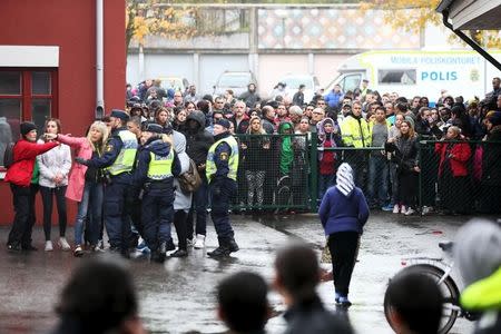 Police officers stand guard at a cordoned area after a masked man attacked people with a sword at a school in Trollhattan, western Sweden October 22, 2015. REUTERS/Bjorn Larsson Rosvall/TT News Agency