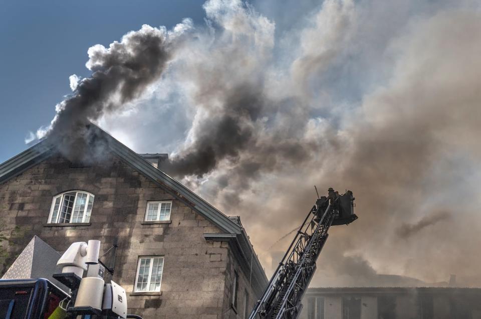 Firefighters respond to a five-alarm fire at the former Monastere du Bon Pasteur, a 19th-century heritage building, on Friday, May 26, 2023 in Montreal. 