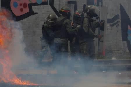 Riot security forces clash with demonstrators during a rally called by health care workers and opposition activists against Venezuela's President Nicolas Maduro in Caracas, Venezuela May 22, 2017. REUTERS/Carlos Barria