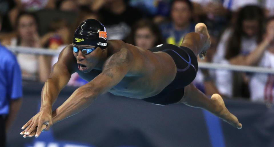 FILE - Cullen Jones dives at the start of his heat in the men's 50-meter freestyle semifinals at the U.S. Olympic swimming trials, in Omaha, Neb., July 1, 2016. Although there is scant scientific evidence that razoring off every bit of exposed hair actually produces faster times, swimmers cling to this tradition before every big meet. (AP Photo/Nati Harnik, File)
