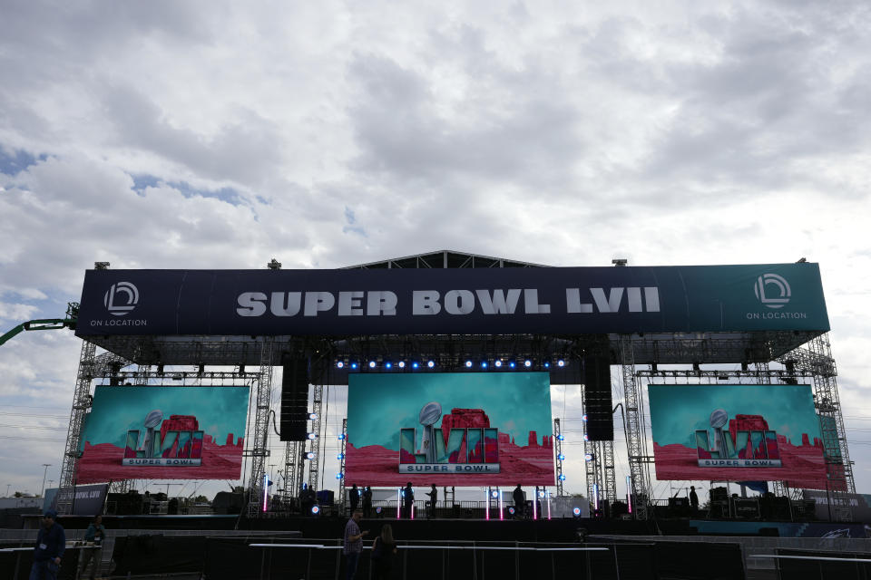 Logos are flashed on a stage outside State Farm Stadium ahead of Super Bowl 57 NFL football game Saturday, Feb. 11, 2023, in Glendale, Ariz. The Kansas City Chiefs will play the Philadelphia Eagles on Sunday. (AP Photo/Marcio Jose Sanchez)