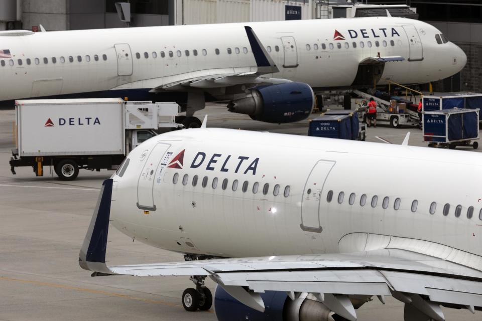 FILE - A Delta Air Lines plane leaves the gate on July 12, 2021, at Logan International Airport in Boston. Delta Air Lines announced Tuesday, Oct. 11, 2022, that it has invested $60 million in a startup that hopes to build electric helicopter-like air taxis to ferry passengers to the airport. (AP Photo/Michael Dwyer, File)