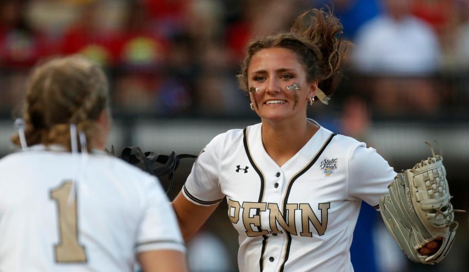 Penn Kingsmen first baseman Abigail Widmar (1) and Penn Kingsmen pitcher Olivia Signorino (3) celebrate during the IHSAA Class 4A Softball State Final against the Roncalli Royals, Saturday, June 10, 2023, at Purdue University’s Bittinger Stadium in West Lafayette, Ind. Penn won 2-1 in nine innings.