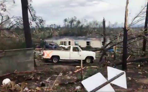Debris in Lee County, Alabama, after what appeared to be a tornado struck in the area - Credit: AP