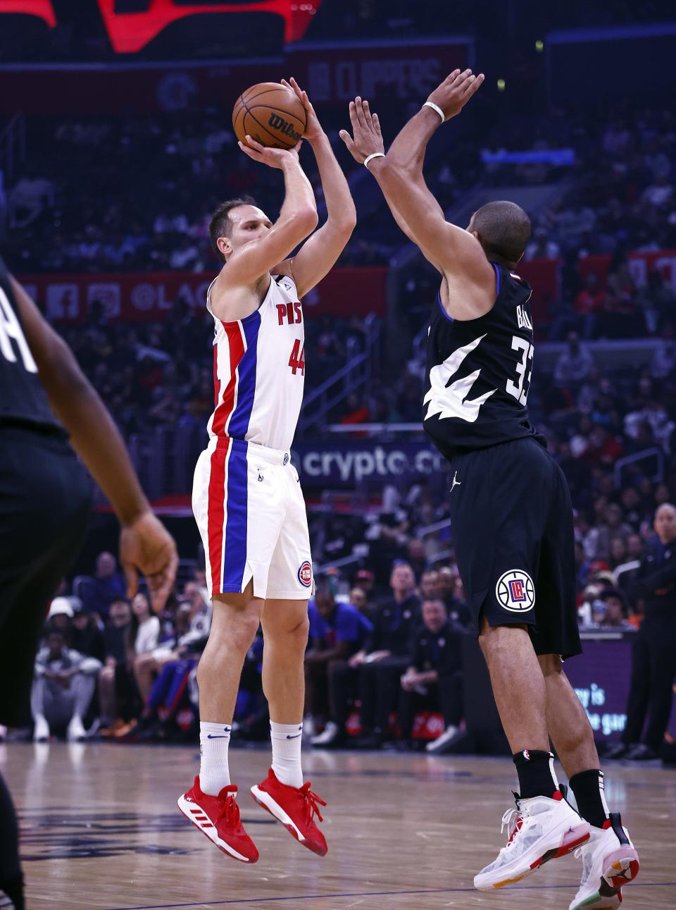 Pistons forward Bojan Bogdanovic takes a shot against Clippers forward Nicolas Batum during the first half on Thursday, Nov. 17, 2022, in Los Angeles.