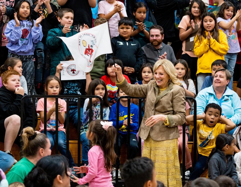 First lady Dr. Jill Biden waves a Menominee Nation flag given to her by a student at Keshena Primary School, one of the stops of her tour to the Menominee Nation, on Tuesday October 10, 2023 in Keshena, Wis.