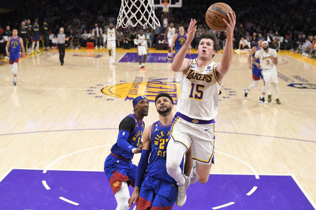 Los Angeles Lakers guard Austin Reaves (15) scores past Denver Nuggets guard Jamal Murray (27) in the first half of Game 3 of the NBA basketball Western Conference Final series Saturday, May 20, 2023, in Los Angeles. (AP Photo/Mark J. Terrill)