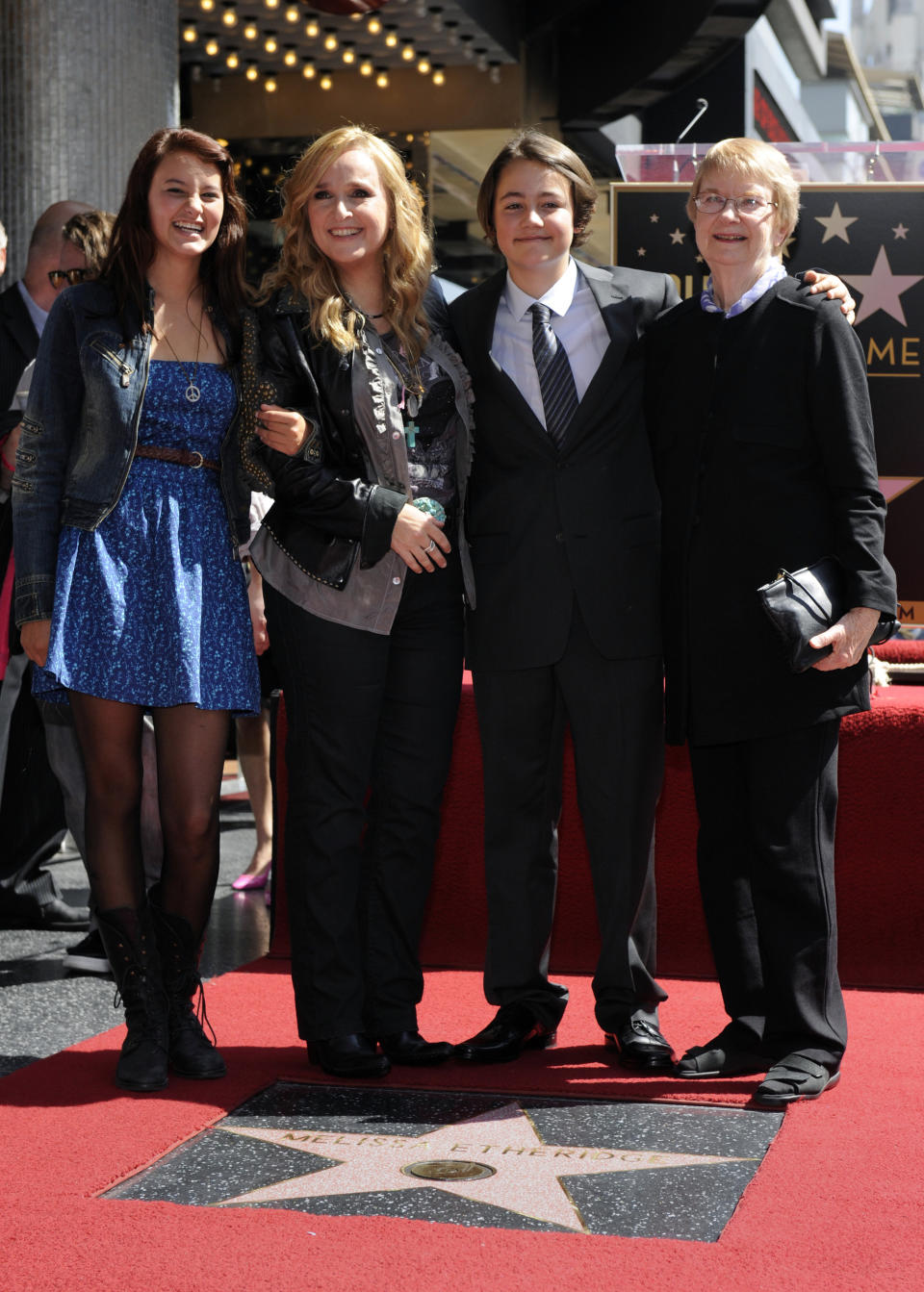 Melissa Etheridge (2nd L) poses with daughter Bailey (L), son Beckett (2nd R) and mother Elizabeth at a ceremony where the singer and songwriter received a star on the Hollywood Walk of Fame in Los Angeles September 27, 2011. REUTERS/Phil McCarten (UNITED STATES - Tags: ENTERTAINMENT)