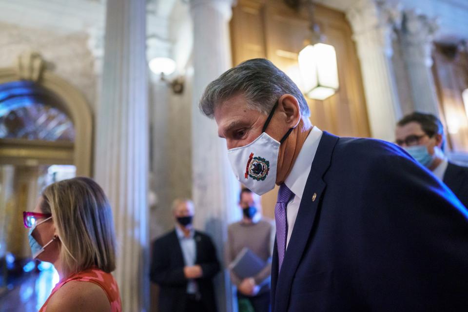 Sen. Joe Manchin, D-W.Va., and Sen. Kyrsten Sinema, D-Ariz., far left, arrive to vote on a temporary government funding bill to avert a shutdown, at the Capitol in Washington, Thursday, Sept. 30, 2021. President Joe Biden appears unable to strike swift agreement with the two wavering Democrats who are pivotal votes for his big $3.5 trillion government overhaul.