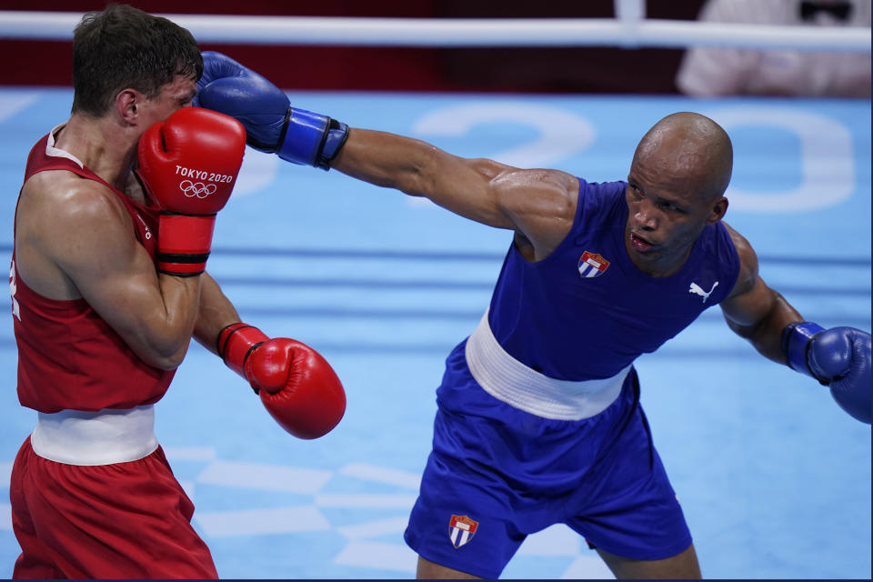 Britain's Pat McCormack, left, exchanges punches with Cuba's Roniel Iglesias during their men's welterweight 69-kg boxing match at the 2020 Summer Olympics, Tuesday, Aug. 3, 2021, in Tokyo, Japan. (AP Photo/Frank Franklin II)