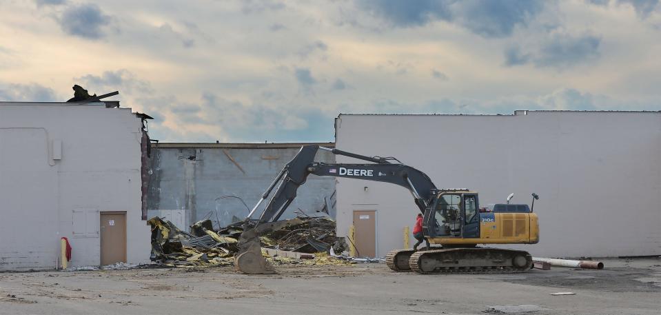Demolition begins at the former K-Mart plaza on Buffalo Road in Harborcreek Township on Feb. 9, 2024. Onlookers stopped and watched from their cars as walls were taken down inside the former Big Lots store there.