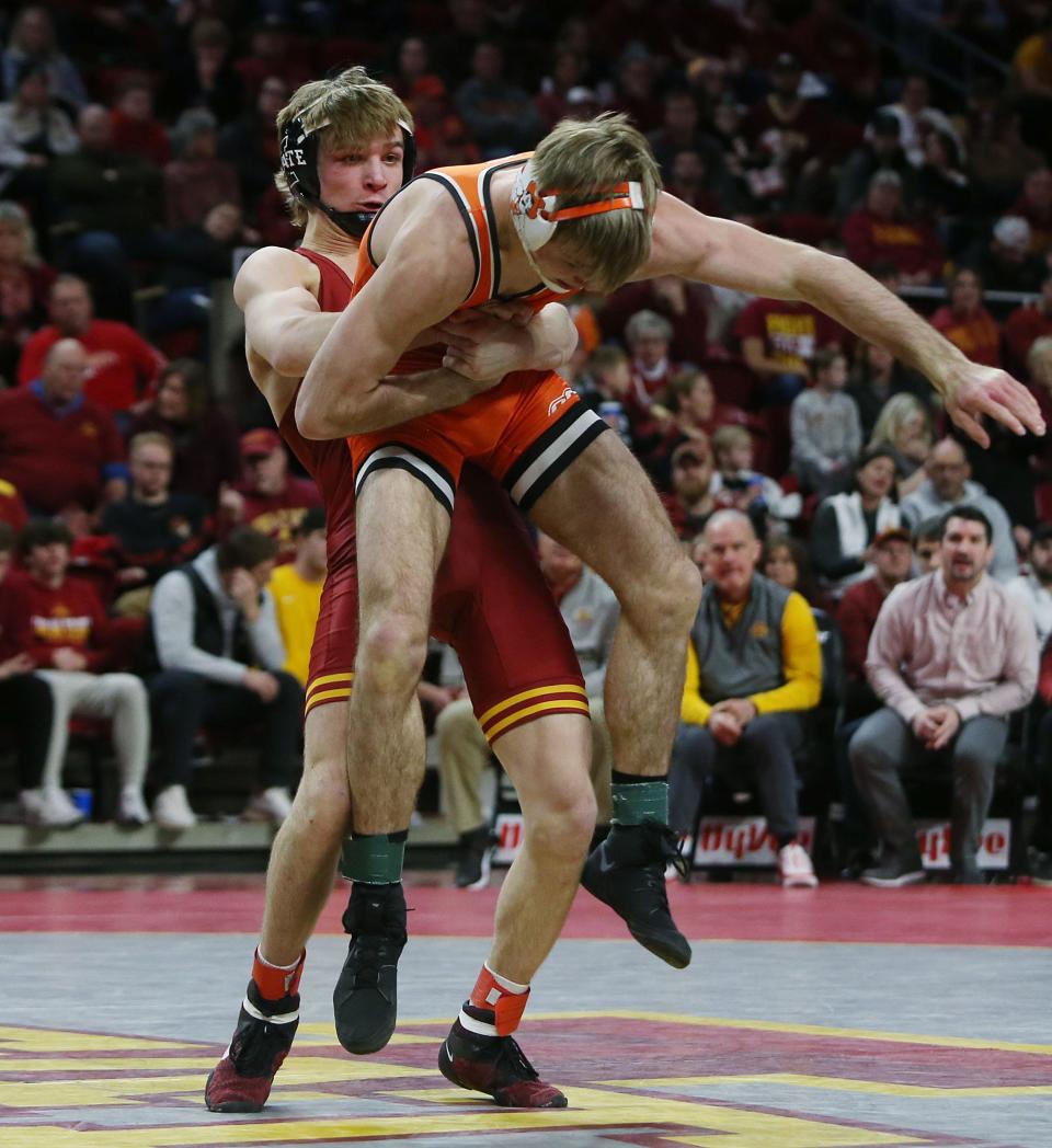 Iowa State Cyclones Casey Swiderski goes for a take-down Oklahoma State Cowboys Carter Young during their 141-pound wrestling in a dual meet at Hilton Coliseum Sunday, Jan. 29, 2023, in Ames, Iowa.