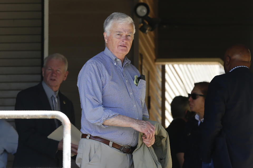 FILE - In this June 7, 2019, file photo, United States District Judge William Alsup, right, leaves the Paradise Performing Arts Center during a tour of fire ravaged Paradise, Calif. Judge William Alsup repeatedly ripped into Pacific Gas & Electric, saying its executives have put greed before safety. Judge Alsup told the utility at a hearing Wednesday, Feb. 19, 2020, that it should plan to have at least 1,100 more tree trimmers to reduce the chances that it will cause even more devastation. The harsh rebuke came in a hearing as part of PG&E's criminal probation imposed after its natural gas lines blew up a San Bruno, California, neighborhood and killed eight people. Since its probation, poorly maintained power lines have been blamed for igniting wildfires that killed nearly 130 people and destroyed thousands of homes. (AP Photo/Rich Pedroncelli, File)