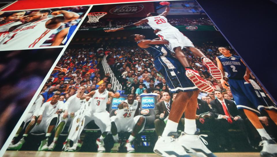 Jul 24, 2023; Columbus, Ohio. With his mouth wide open, former Ohio State men's basketball player Matt Terwilliger (second from left) watches Greg Oden dunk a basketball during a Final Four game. The photo is part of a wall display inside the Schottenstein Center. Since leaving basketball, Terwilliger is running his own wealth advisory company. 