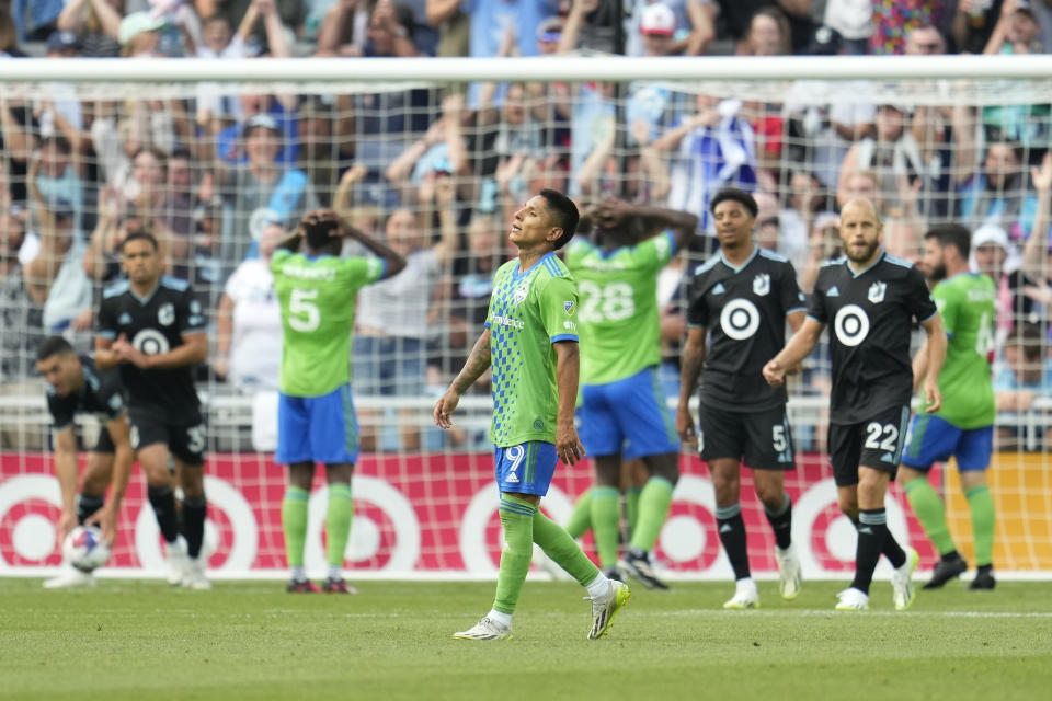 Seattle Sounders forward Raúl Ruidíaz, center, reacts after an own-goal by teammate Yeimar Gómez during the second half of an MLS soccer match against Minnesota United, Sunday, Aug. 27, 2023, in St. Paul, Minn. (AP Photo/Abbie Parr)