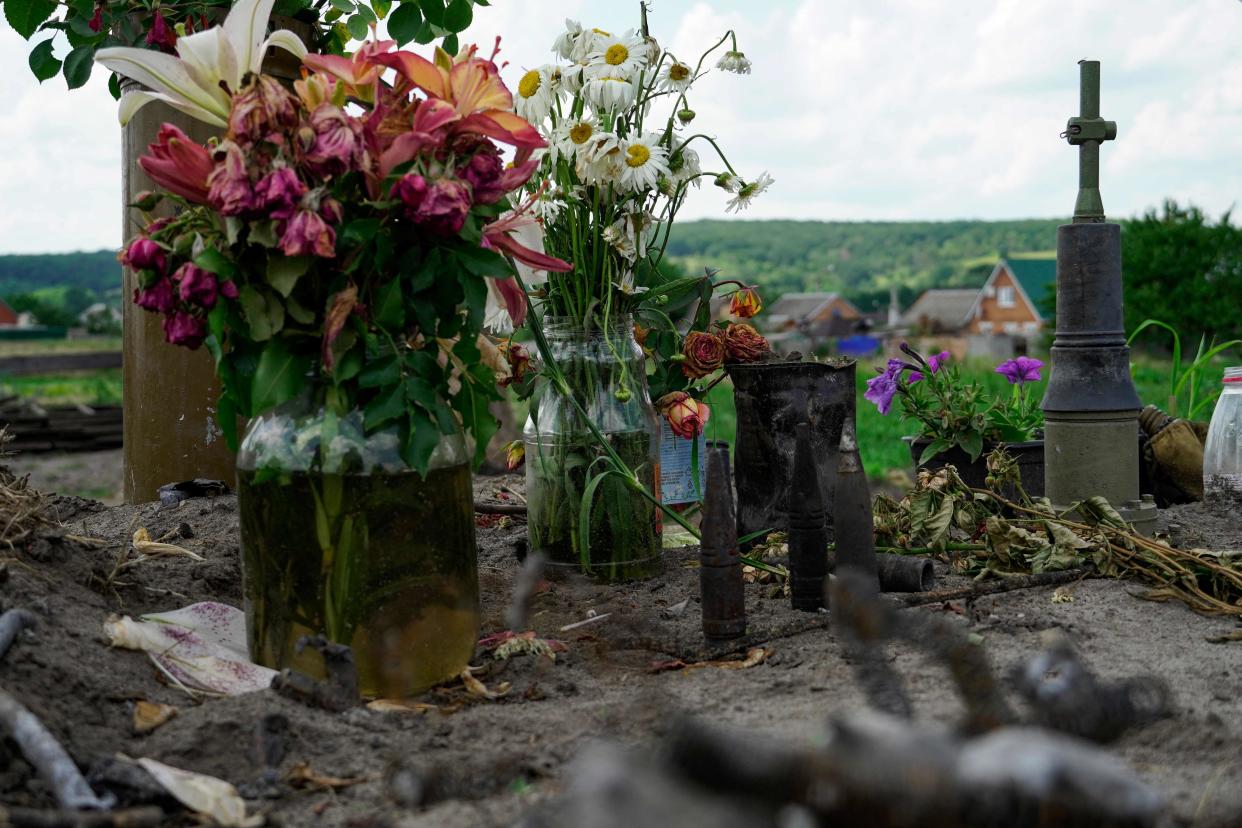 Flowers are seen left at the site of fighting with a sabotage and reconnaissance group of the Ukrainian armed force in the village of Novaya Tavolzhanka, near the border with Ukraine in the Belgorod region (AFP via Getty Images)