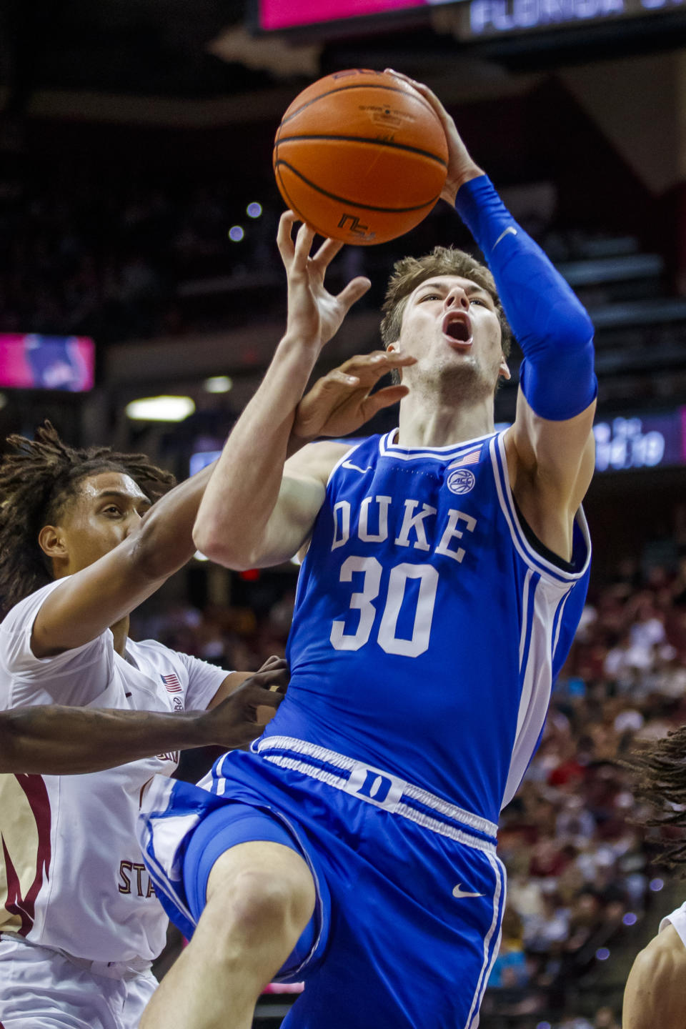 Duke center Kyle Filipowski (30) drives by Florida State forward Baba Miller (11) during the first half of an NCAA college basketball game, Saturday, Feb. 17, 2024, in Tallahassee, Fla. (AP Photo/Colin Hackley)