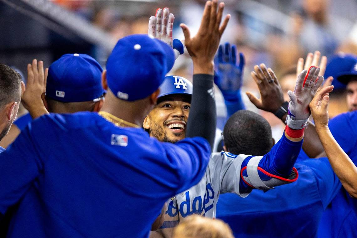 Los Angeles Dodgers base runner Mookie Betts (50) reacts with teammates after hitting a home run during the seventh inning of an MLB game against the Miami Marlins at loanDepot park in the Little Havana neighborhood of Miami, Florida, on Friday, August 26, 2022.