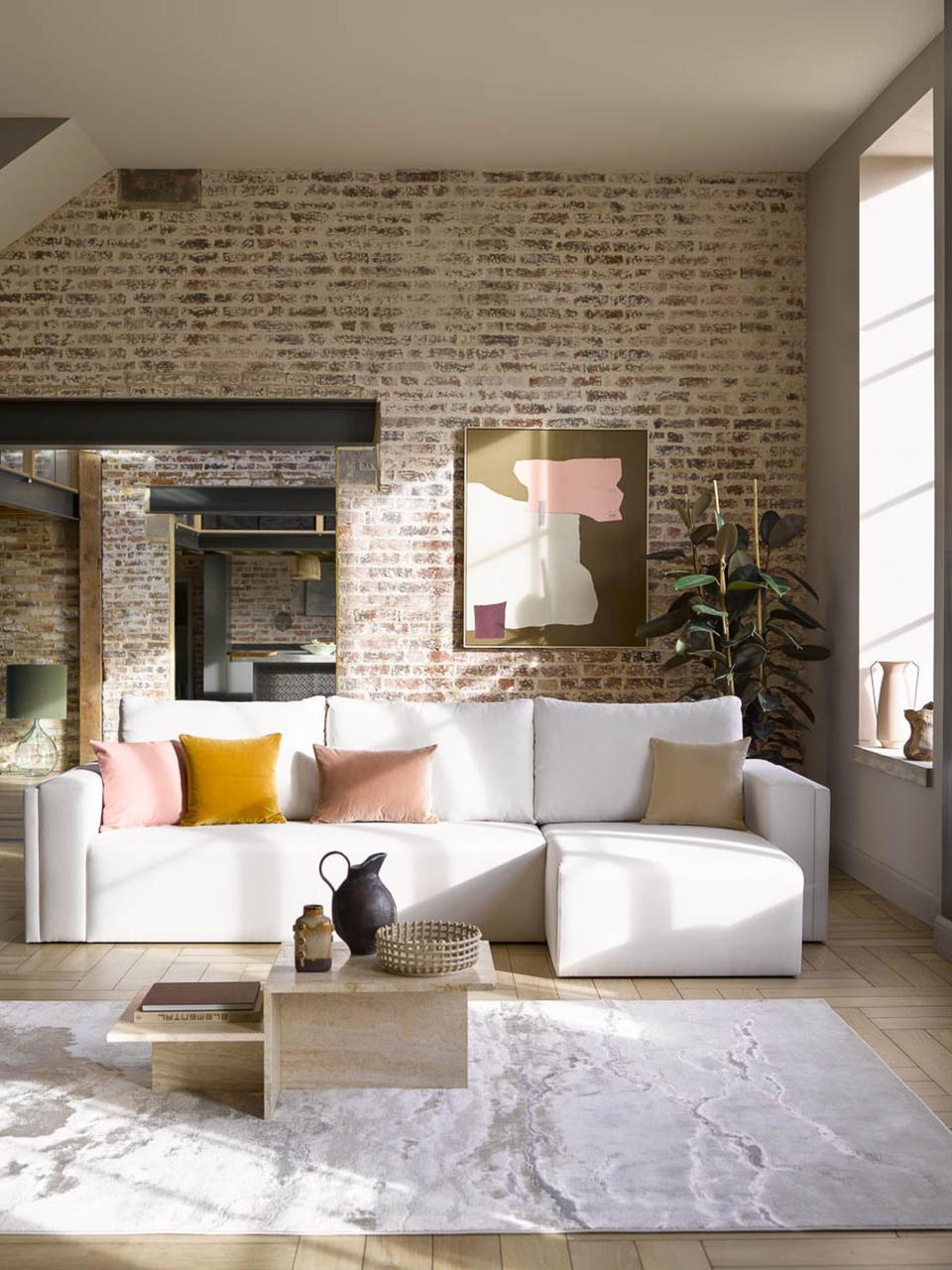 <p> 'Textures are key to making any space work and in an apartment you can use them to add depth. Remember that you need to use smooth textures too for contrast – like this sectional couch which looks fabulous against the exposed brick walls, add in the tactile velvet pillows and use of wood and the space is full of character and style,' says Jennifer Ebert, digital editor, <em>Homes & Gardens </em> </p>