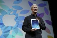 Apple Inc CEO Tim Cook holds up the new iPad Air during an Apple event in San Francisco, California October 22, 2013. REUTERS/Robert Galbraith (UNITED STATES - Tags: BUSINESS TELECOMS SCIENCE TECHNOLOGY TPX IMAGES OF THE DAY)