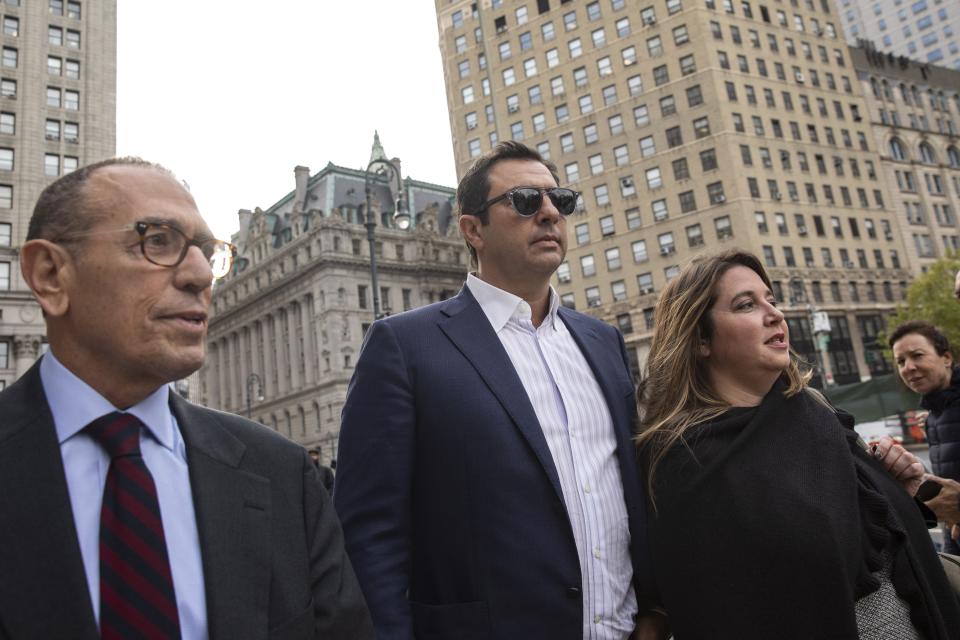 Andrey Kukushkin (center) leaves a hearing Manhattan federal court arraignment in New York City on October 17, 2019, with defense attorneys Gerald Lefcort, (left) and Faith Friedman (right).