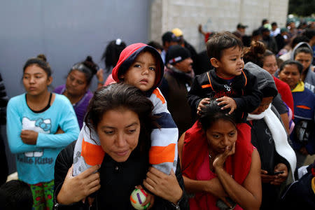 Members of a migrant caravan from Central America line up to receive breakfast at the end of their journey through Mexico, prior to preparations for an asylum request in the U.S., at a shelter in Tijuana, Baja California state, Mexico April 27, 2018. REUTERS/Edgard Garrido