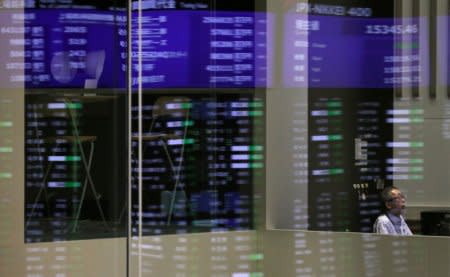 Market prices are reflected in a glass window at the Tokyo Stock Exchange (TSE) in Tokyo, Japan, February 6, 2018.  REUTERS/Toru Hanai