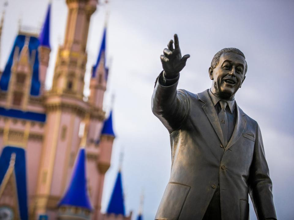 The Cinderella Castle and Walt Disney's statue inside Magic Kingdom Park at Walt Disney World resort.