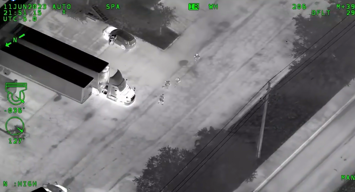 This video screengrab shows the trucker stepping into the path of the suspect as he ran through a parking lot.
